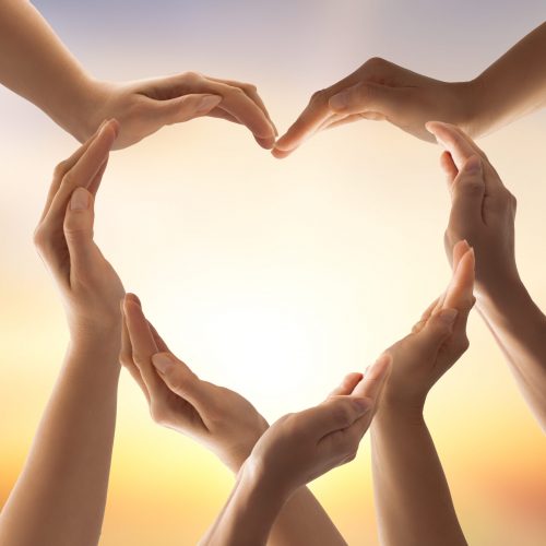 Symbol and shape of heart created from hands.The concept of unity, cooperation, partnership, teamwork and charity.
